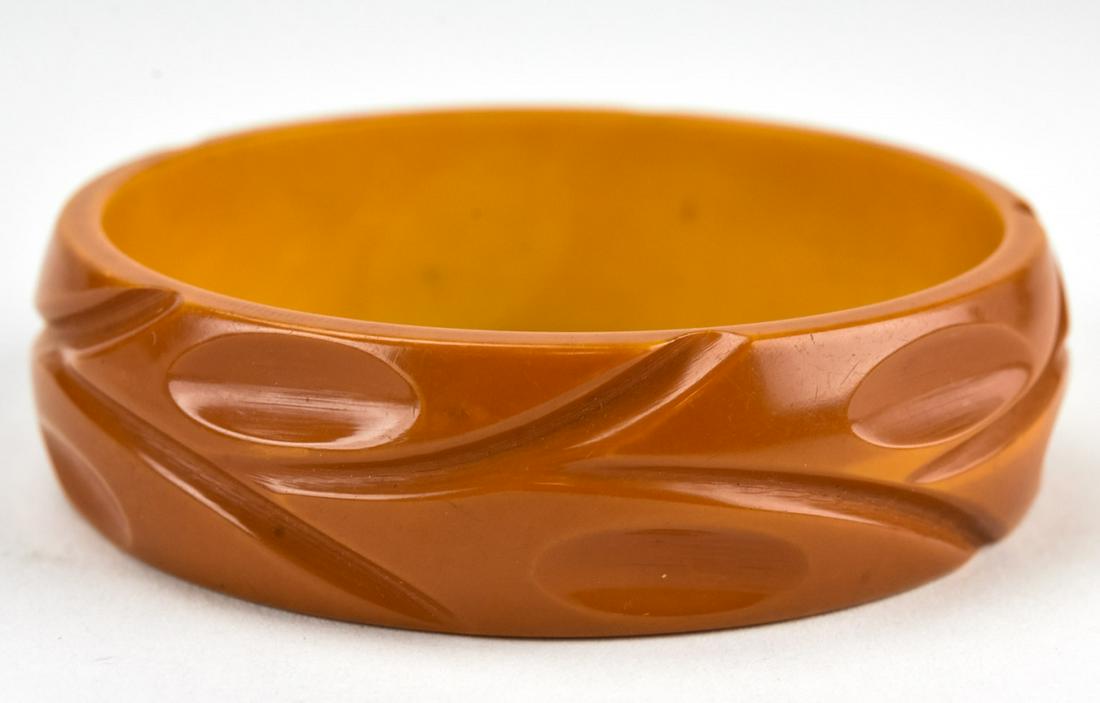 Wide Carved Butterscotch Bakelite Bangle Bracelet: Wide Carved Butterscotch Bakelite Bangle Bracelet. Measures 6/8 of an inch wide, 2.5 inches across the interior opening. Circa 1945.
