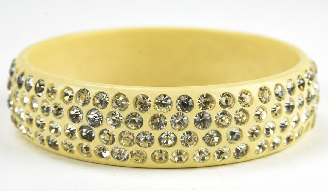 Art Deco C 1920 Celluloid Sparkle Bangle Bracelet: Art Deco C 1920 Celluloid Sparkle Bangle Bracelet. Cream with paste stones. Measures 2 3/8 inches across the interior opening. 5/8 of an inch wide.