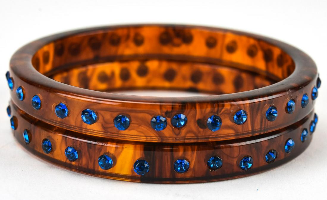Pair Tortoise Bakelite & Paste Bangle Bracelets: Pair Tortoise Bakelite & Paste Bangle Bracelets. Set with blue pastes stones, circa 1945. Each measures 2.5 inches across the interior opening.