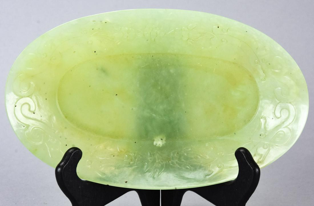 Chinese Carved Jade Pin Tray: Chinese Carved Jade Pin Tray. Oblong pin tray with carved floral pattern surrounding the interior. Tests as jadeite on the presidium. Measures 1.5 inches x 8.75 inches x 5.25 inches.