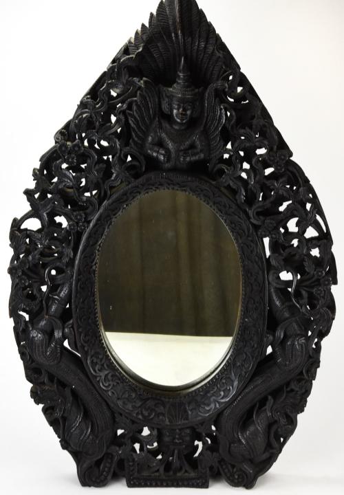 Antique Ornately Carved and Pierced Thai Mirror: Antique Ornately Carved and Pierced Thai Mirror. Heavily carved oval mirror with serpent and diety motifs. 32 inches x 20 inches x 3 inches deep.