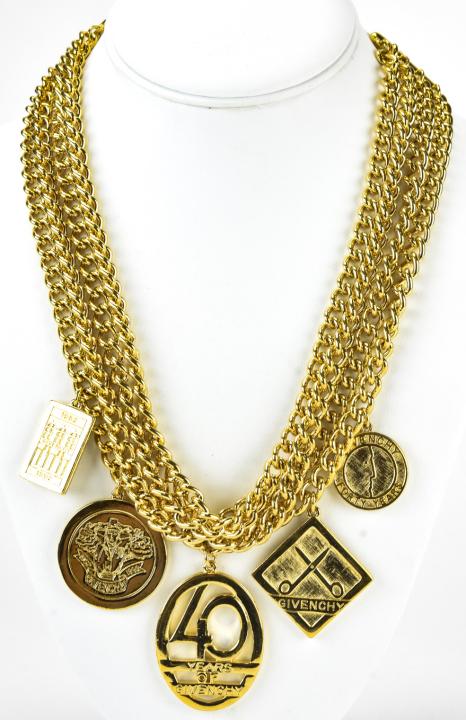 Givenchy C 1992 40 Year Anniversary Charm Necklace: Givenchy C 1992 40 Year Anniversary Charm Necklace. Rare Givenchy 40 year anniversary gilt metal 4 strand charm necklace. Charms are double sided. 21 inches.