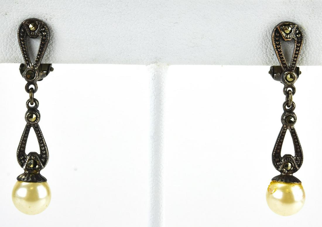 Silver Tone Marcasite & Faux Pearl Earrings: Silver Tone Marcasite & Faux Pearl Earrings. Pair clip earrings with marcasite and faux pearl drops. Each measures 1.5 inches in length.