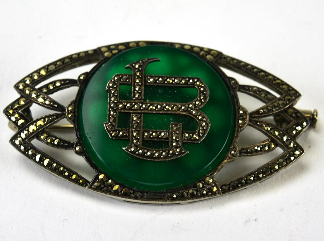 French Sterling Agate & Marcasite Deco Brooch: French Sterling Agate & Marcasite Deco Brooch. Deco brooch modeled in sterling silver with marcasite and green agate. Monogrammed initials at center. Measures 2 inches x 1 inch.