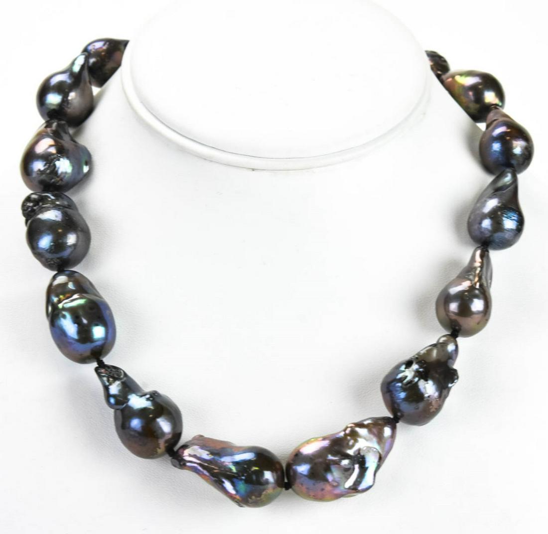 Cultured Black Baroque Pearl Necklace Strand: Cultured Black Baroque Pearl Necklace Strand w Graduated Size Pearls. Hand knotted on silk thread. Measures 18.5 inches in length.
