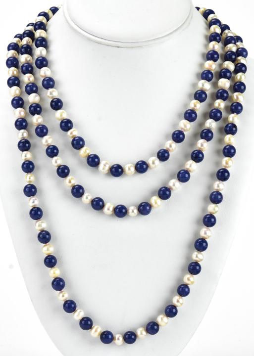 Opera Length Hand Knotted Lapis & Pearl Necklace: Opera Length Hand Knotted Lapis & Pearl Necklace. Hand knotted on white silk thread with lapis lazuli beads and baroque pearl beads. Measures approximately 66 inches in length.