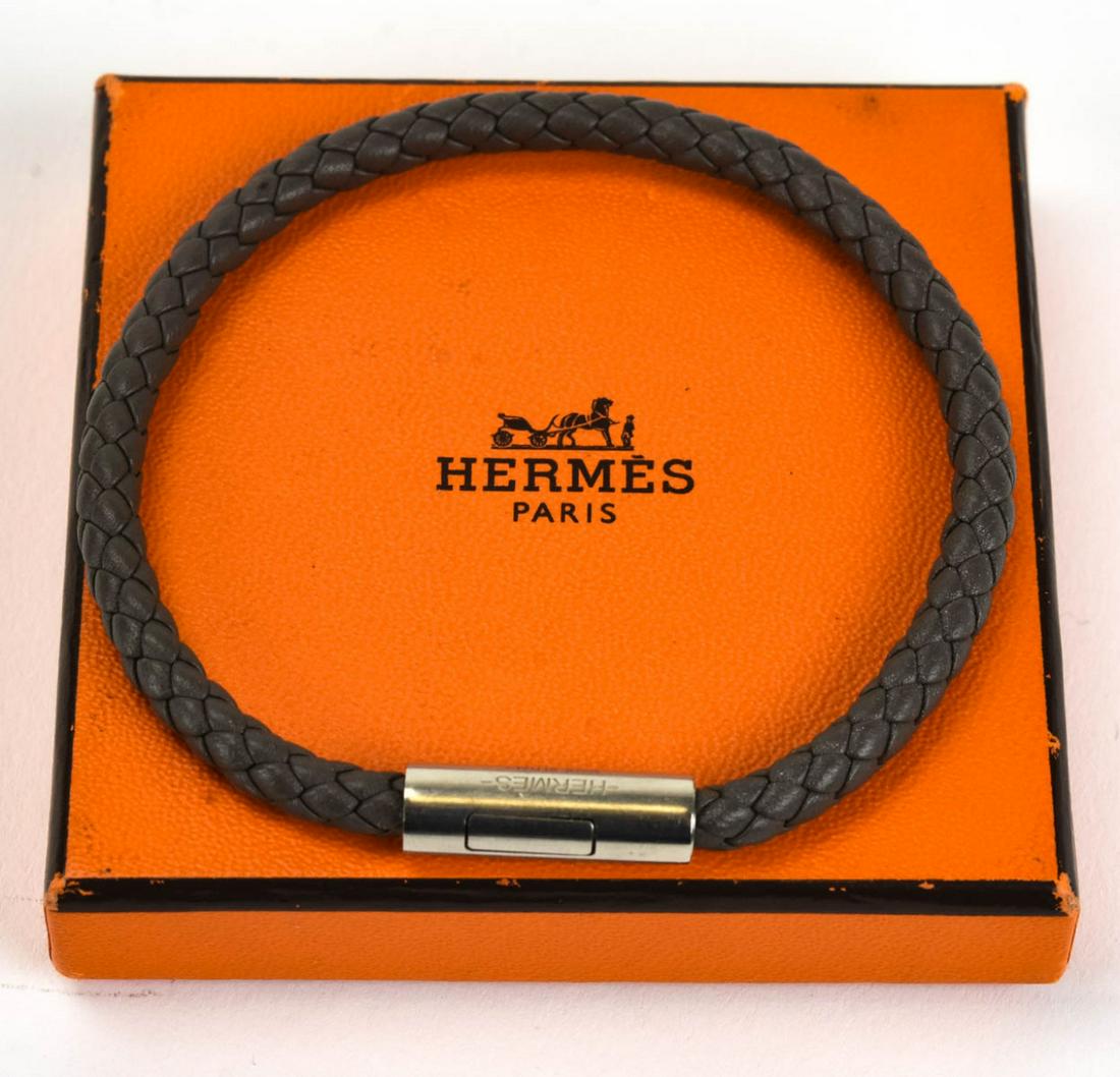 Hermes Paris Woven Leather Bracelet w Original Box: Hermes Paris Woven Leather Bracelet w Original Box. This is a grey silver Goliath model woven calf skin leather bracelet with palladium plated hardware. Measures 8.25 inches in length.