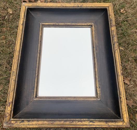 Antiqued Gilt & Painted Mirror: Antiqued Gilt & Painted Mirror. Mirror with wood frame and weathered gilt and dark paint. Measures 26 inches x 22 inches.
