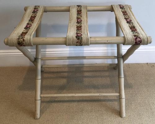 Mid Century Faux Bamboo Needlepoint Luggage Stand: Mid Century Faux Bamboo and Needlepoint Luggage Stand. Painted ivory with 3 straps of needlepoint. 20 inches x 24 inches x 15 inches