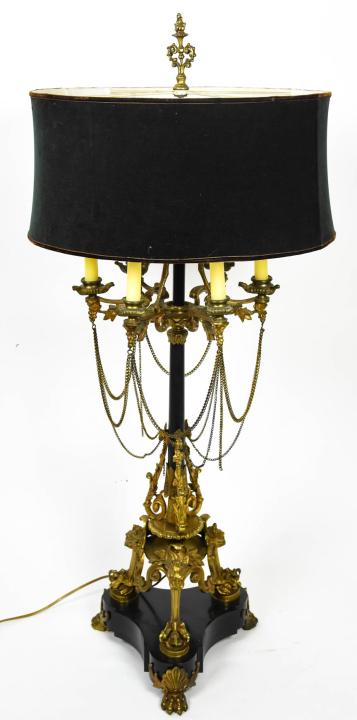 Antique French Empire Gilt Ormolu Candelabra Lamp: Antique French Empire Gilt Ormolu Candelabra Lamp. Electrified candelabra lamp with gilt brass ormolu chaining, lion heads and claw feet. with velvet shade. Measures 38 inches x 18 inches.