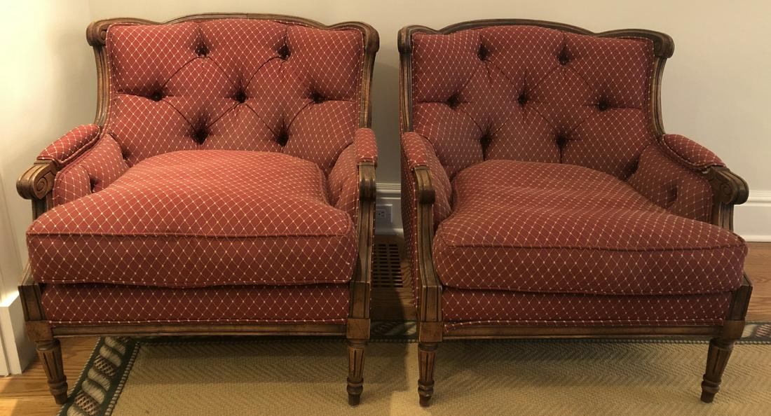 Pair French Country Bergere Upholstered Arm Chairs: Pair French Country Bergere Style Upholstered Arm Chairs. Tufted upholstered chair with separate seat cushion and carved arms and legs. Rounded back. 30 inches x 30 inches x 34 inches