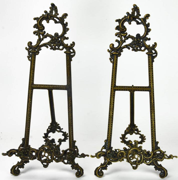 2 Antique Brass French Rococo Style Display Stands: 2 Antique Brass French Rococo Style Display Stands. Each measures 21.5 inches x 10 inches x 8 inches.