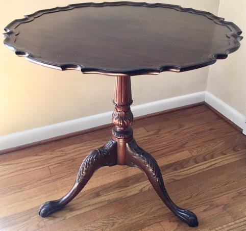 Chippendale Style Pie Crust Occasional Table: Chippendale Style Pie Crust Occasional Table. With hand carved pedestal and paw feet. 31 inches x 32 inches.