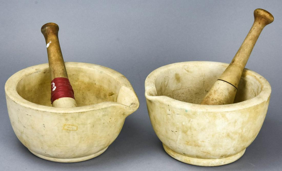 2 Antique Acme Mortars & Pestles: 2 Antique Acme Mortars & Pestles. Both mortars are marked on bottom, pestles with wooden handles. Mortar measures 4.5 inches x 8.25 inches in diameter.