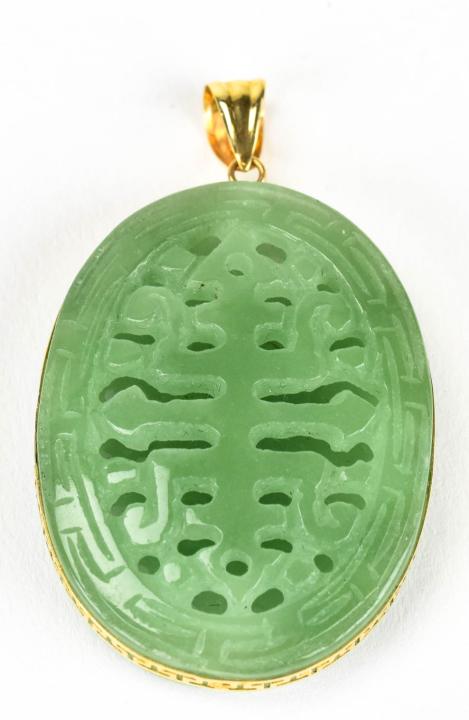 Estate 14kt Yellow Gold & Jade Necklace Pendant: Estate 14kt Yellow Gold & Jade Necklace Pendant. Tests as Jadeite on the Presidium. Carved with character front and back. Measures just over 2 inches in length.