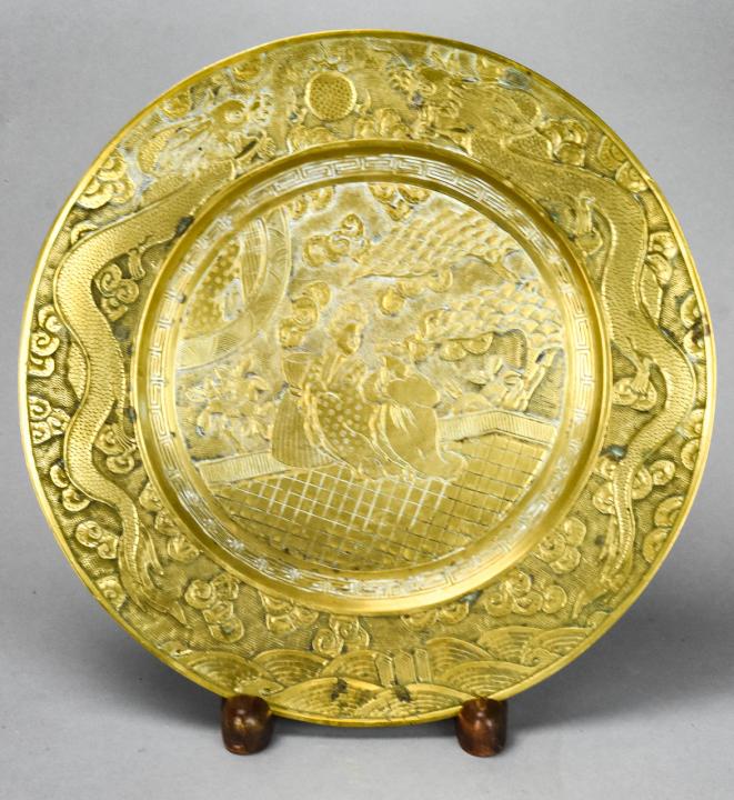 Chinese Imperial Mark Brass Charger: Chinese Imperial Mark Brass Charger. With figural and dragon motif and imperial mark on back. Measures 10.75 inches in diameter.
