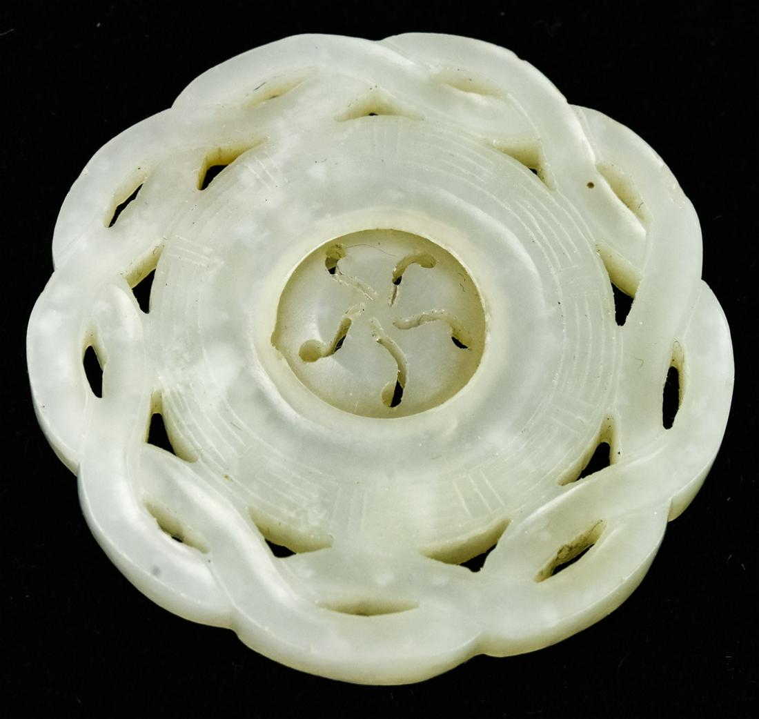 Chinese Hand Carved Green Jade Spinner Disc: Chinese Hand Carved Green Jadeite Spinner Disc. Carved from one piece of jade, when center portion is held the frame can be spun around it. Measures just over 2 inches in diameter. Tests as Jadeite on