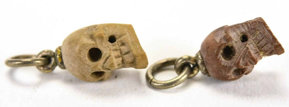 Pair of Italian Vesuvius Carved Lava Stone Skulls: Pair of Italian Vesuvius Carved Lava Stone Skulls. Memento mori human skull charms or necklace pendants. Each measures approximately 5/8ths of an inch in length with bail.
