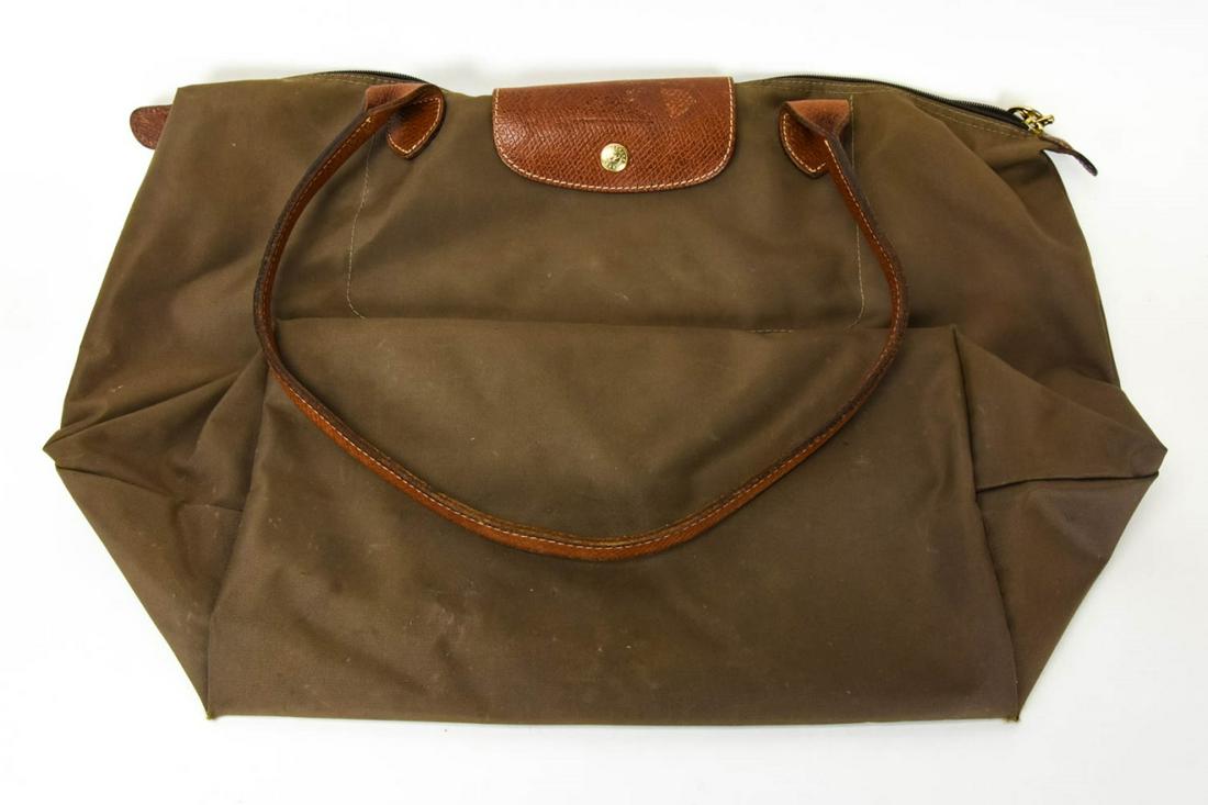 Longchamp Leather & Canvas Tote Bag / Purse: Longchamp Leather & Canvas Tote Bag / Purse. Olive green canvas with brown leather straps, brass hardware. Measures 13 inches x 19 inches without straps.
