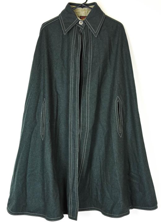 Anne Klein Wool Sleeveless Cape: Anne Klein Wool Sleeveless Cape. Exposed stitch wool cape by Anne Klein. Measures approximately 18 inches across shoulders, 41 inches total length.