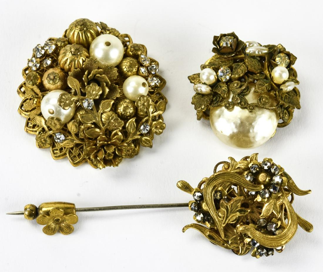 Vintage Miriam Haskell Gilt Metal Brooches & Pin: Vintage Miriam Haskell Gilt Metal Brooches & Pin. Unsigned stick pin, brooch signed Miriam Haskell, unsigned brooch. Stick pin measures 3.25 inches in length.