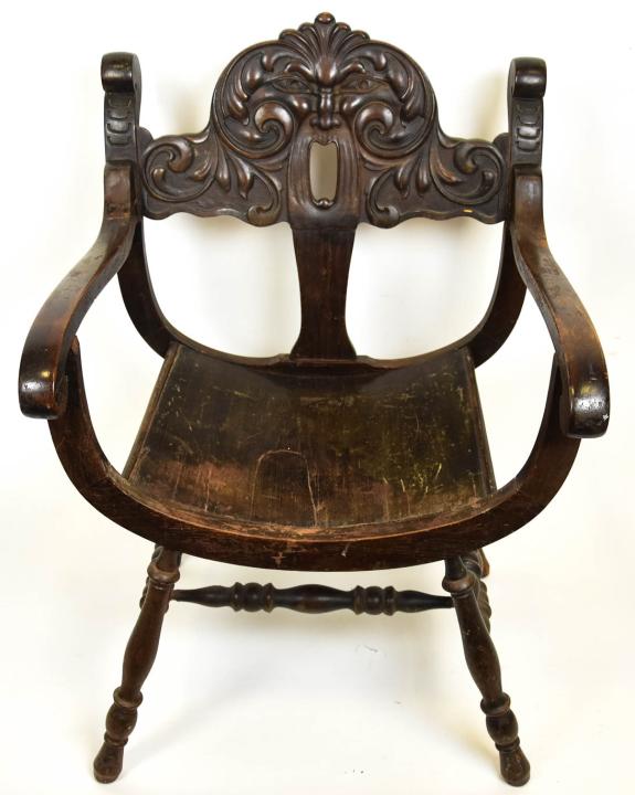 Antique Hand Carved North Wind Arm Chair: Antique Hand Carved North Wind Arm Chair. Antique dark wood arm chair with hand carved north wind face back splat. Measures 35.5 inches x 23.5 inches x 17.5 inches.