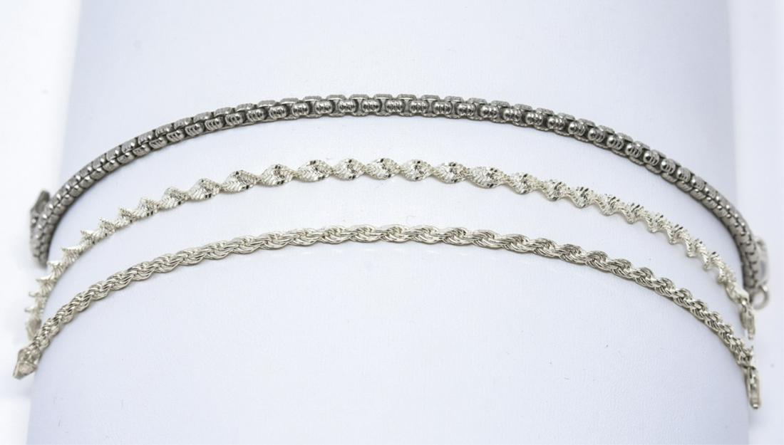 Three Sterling Silver Chain Bracelets: Three Sterling Silver Chain Bracelets. Longest measures 9 inches in length.