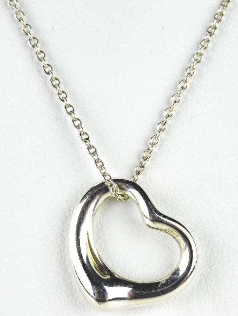 Tiffany Sterling Elsa Peretti Heart Necklace: Vintage Tiffany Sterling Elsa Peretti Heart Necklace. Authentic stamped Tiffany necklace with on 16” Tiffany Sterling chain. Fully hallmarked on the pendant and chain. Approximately 3.4 grams.