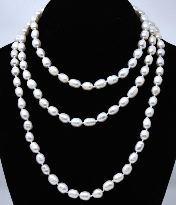 Hand Knotted High Luster Baroque Pearl Necklace: Hand Knotted High Luster Baroque Pearl Necklace. Hand knotted on white silk thread. Measures nearly 52 inches in length.
