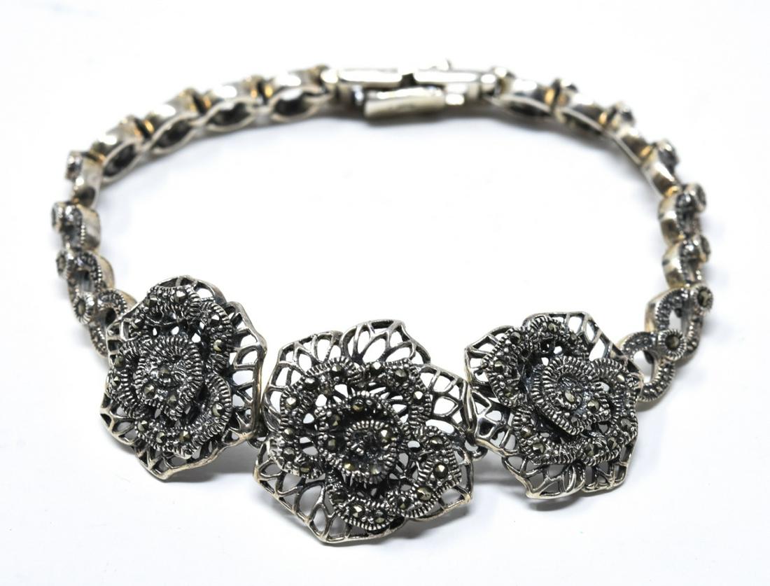 Sterling Silver & Marcasite Floral Motif Bracelet: Sterling Silver & Marcasite Floral Motif Bracelet. Measures 7.75 inches in length. Weighs approximately 30 grams inclusive.