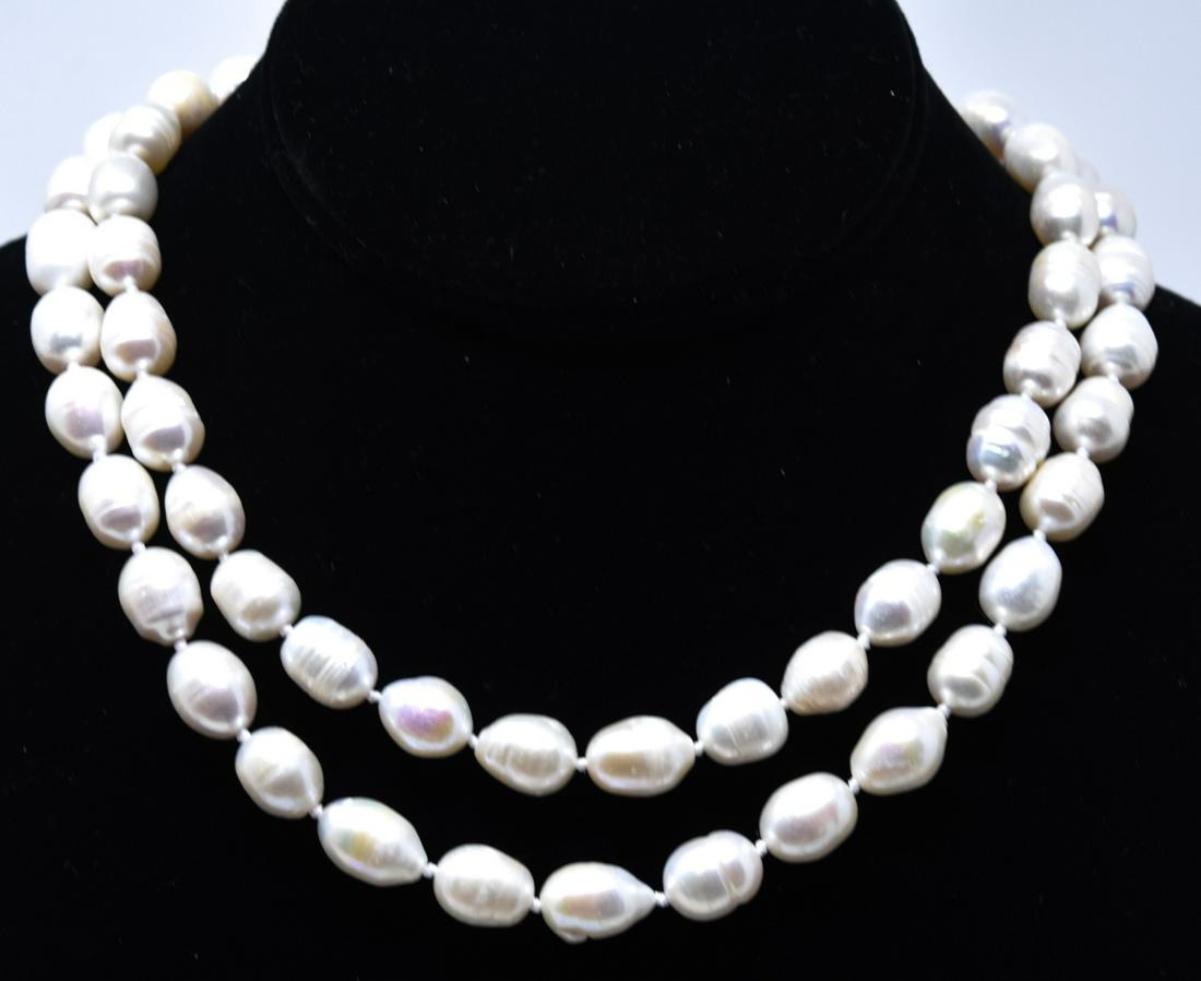 Hand Knotted Baroque Pearl Opera Length Necklace: Hand Knotted Baroque Pearl Opera Length Necklace. Hand knotted on white silk thread. Measures 35 inches in length.