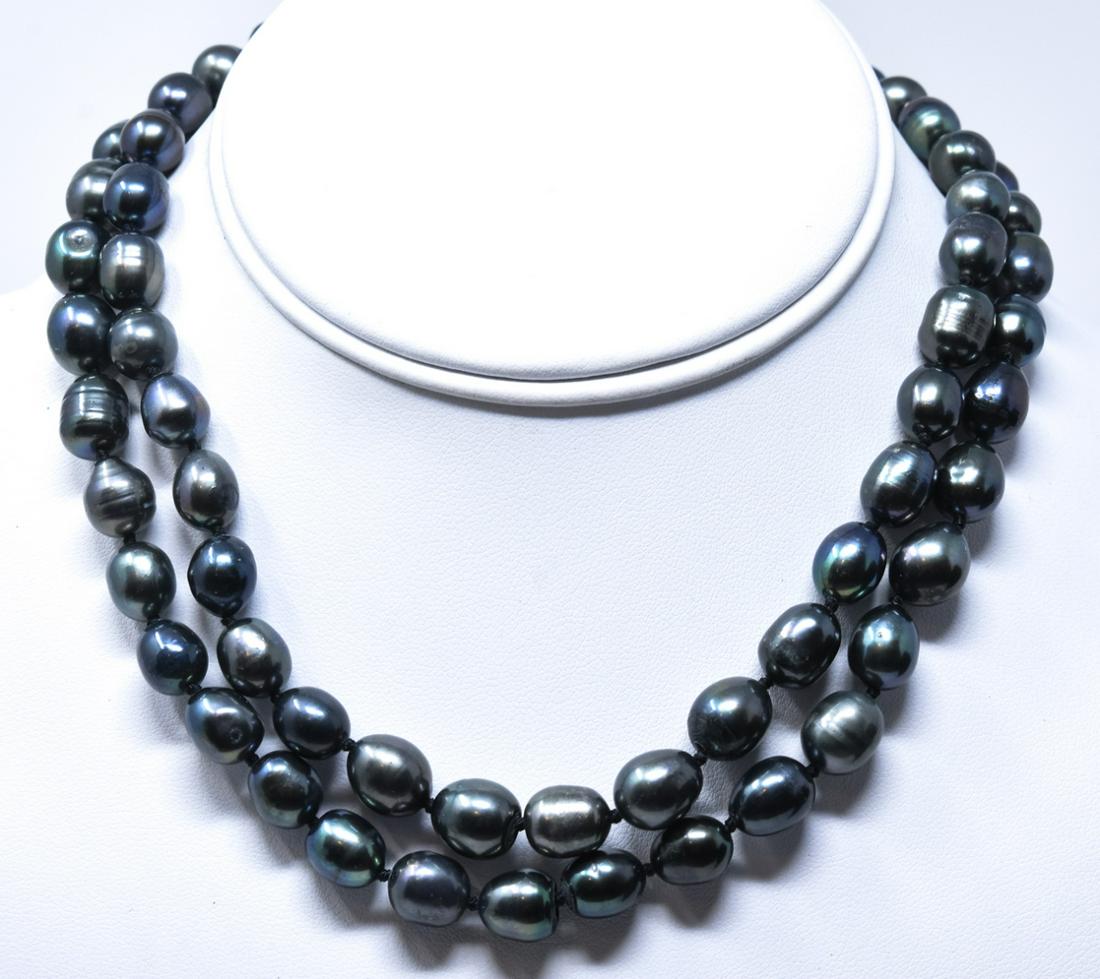 Pair of Cultured Tahitian Black Pearl Necklaces: Pair of Cultured Tahitian Black Pearl Necklaces. Hand knotted on black silk thread with tones of black, gray and silver. Filigree clasps. Each measures approximately 18 inches in length.