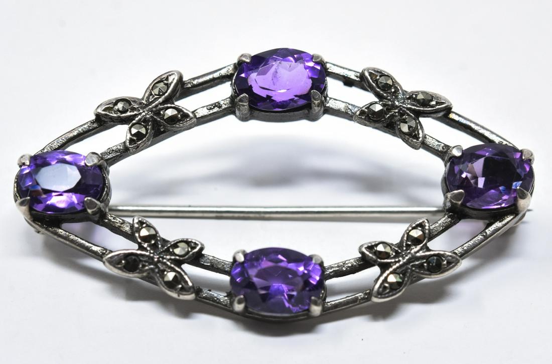 Sterling Silver Amethyst & Marcasite Brooch: Sterling Silver Amethyst & Marcasite Brooch. Open diamond form frame design. Measures 1.75 inches in width.