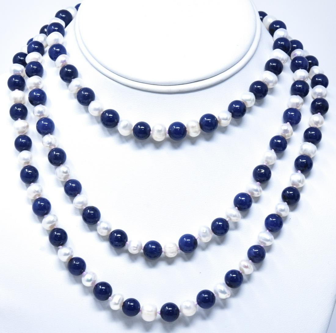 Hand Knotted Baroque Pearl & Lapis Lazuli Necklace: Hand Knotted Baroque Pearl & Lapis Lazuli Necklace. Measures 50 inches in length.