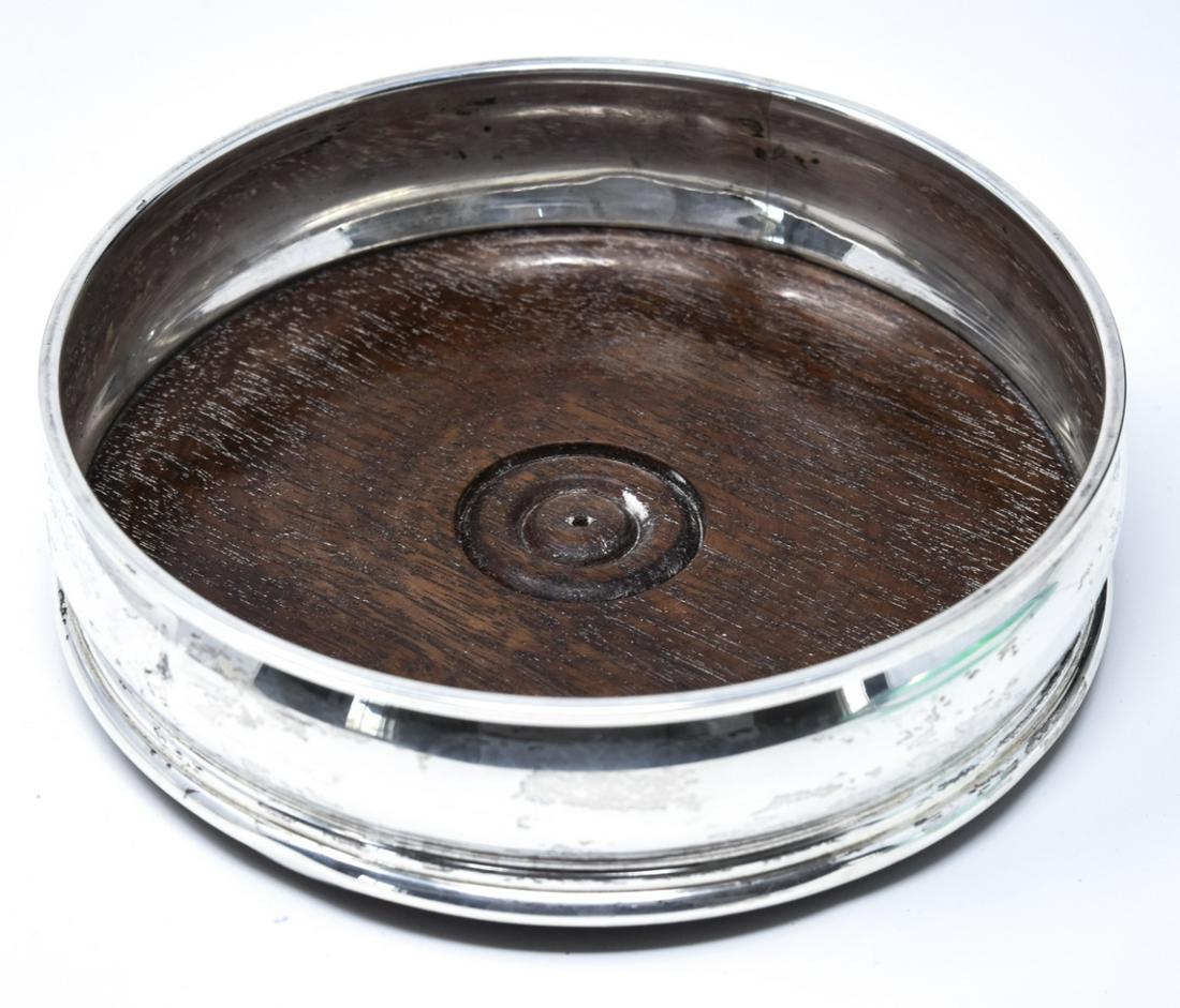 English Sterling Silver & Wood Wine Bottle Coaster: English Sterling Silver & Wood Wine Bottle Coaster. Hallmarked. Measures 5 inches in diameter.