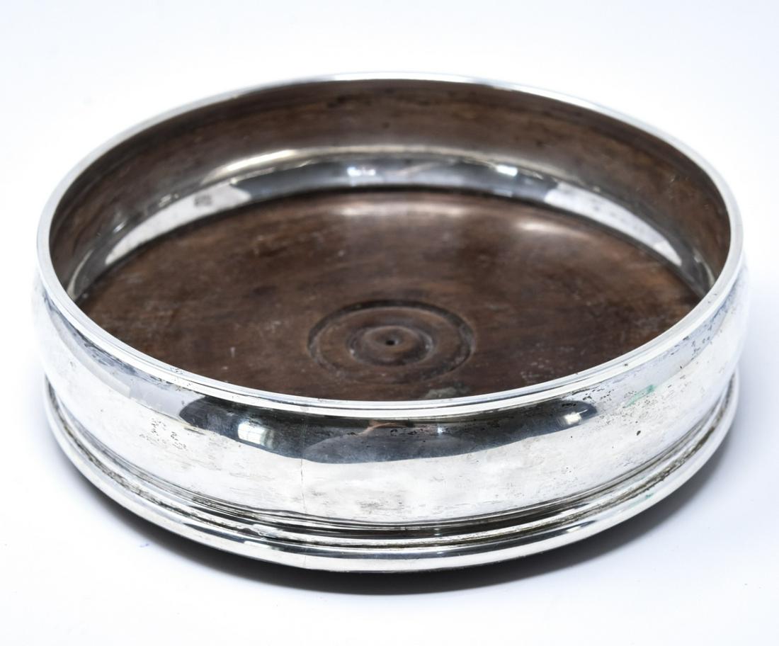 English Sterling Silver & Wood Wine Bottle Coaster: English Sterling Silver & Wood Wine Bottle Coaster. Hallmarked. Measures 5 inches in diameter.