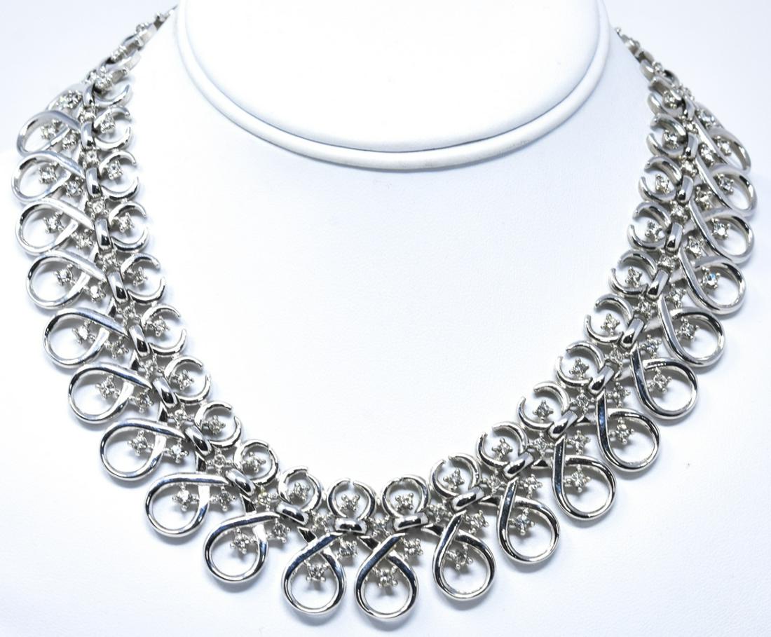 Vintage Crown Trifari Rhodium Plate Necklace: Vintage Crown Trifari Rhodium Plate Necklace. Rhodium plated open scrollwork and rhinestone collar form necklace. Signed on clasp. Measures 16.25 inches in length.
