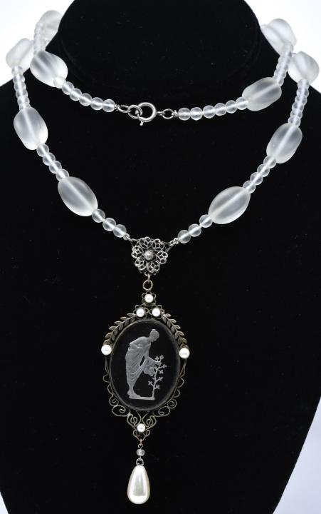 Antique C 1920s Carved & Frosted Glass Necklace: Antique C 1920s Carved & Frosted Glass Necklace. Frosted glass beads with reverse intaglio pendant of a lady and rose brush in faux pearl setting. Measures 28 inches in length plus pendant drop.