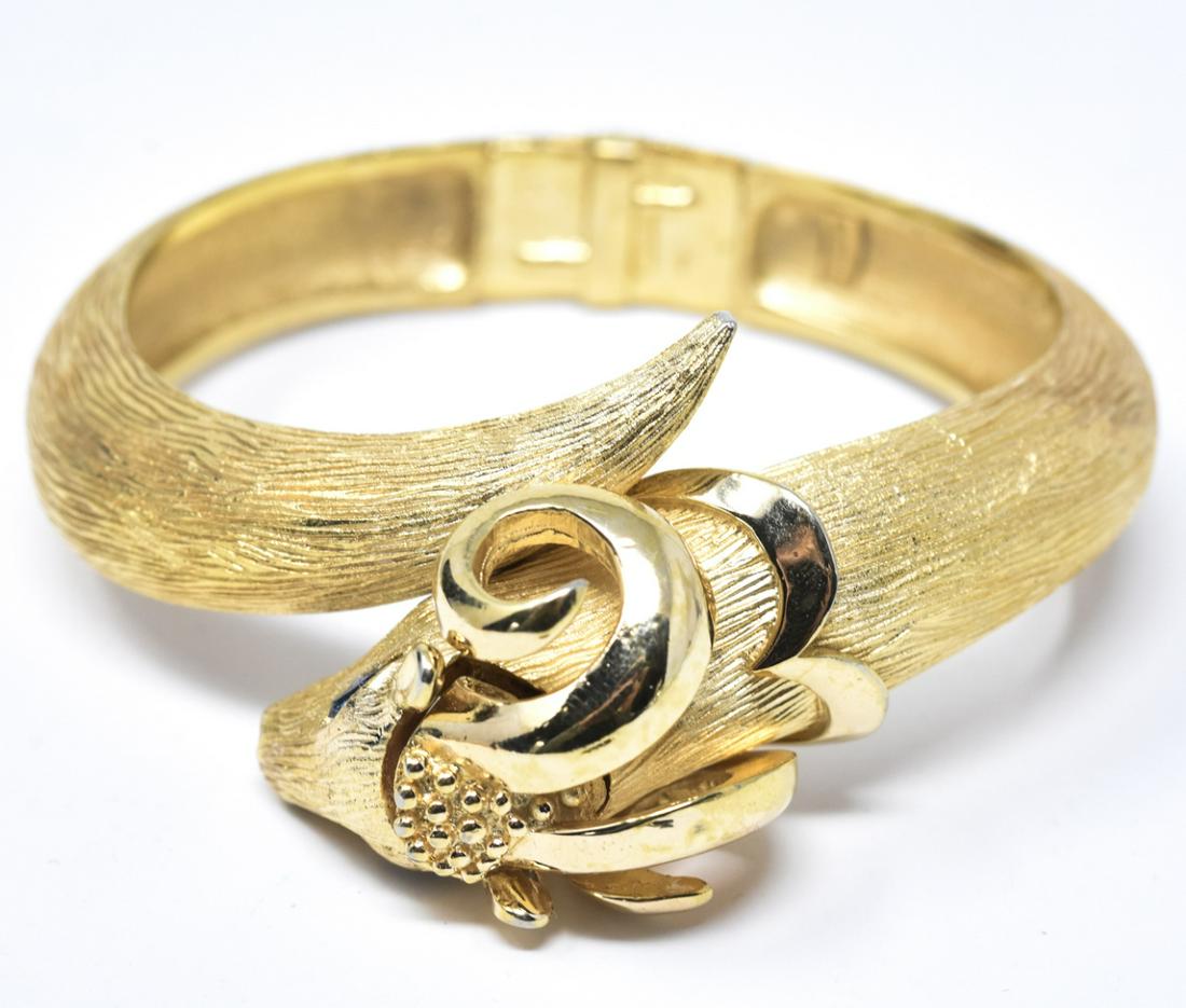 Vintage C 1970s Trifari Gilt Ram's Head Bracelet: Vintage C 1970s Trifari Gilt Ram's Head Bracelet. Textured and high shine gilt metal with sapphire paste eyes. Measures 2.25 inches across the opening.