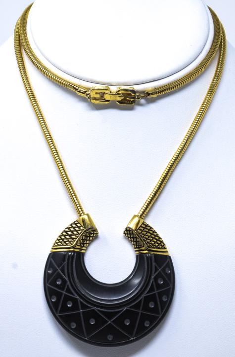 Vintage French Gilt Metal Necklace by Givenchy: Vintage French Gilt Metal Necklace by Givenchy. Articulated snake chain, stylized crescent moon pendant. Signed. Measures 25 inches plus pendant.