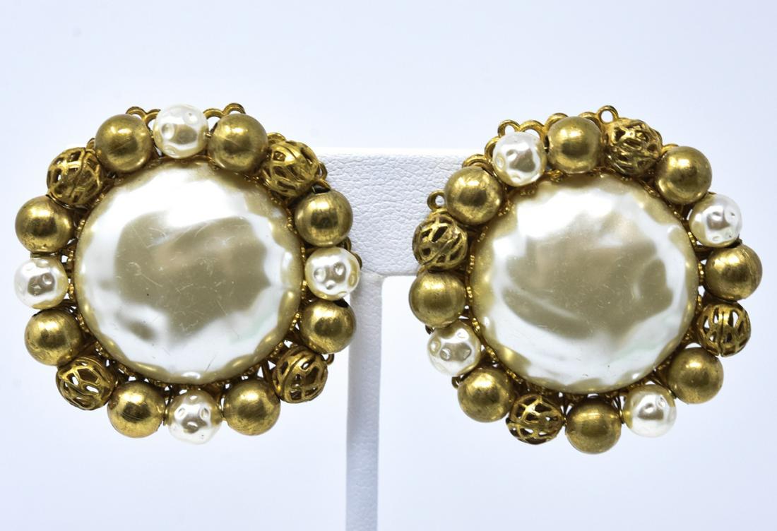 Pair of Vintage Miriam Haskell Clip on Earrings: Pair of Vintage Miriam Haskell Clip on Earrings. Signed on backs. Large faux mabe pearls with faux pearl and gold tone bead halo. Each measures 1.25 inches in diameter.