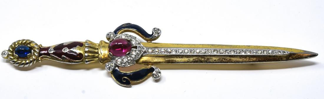 Rare Vintage Trifari Excalibur Sword Brooch Pin: Rare Vintage Trifari Excalibur Sword Brooch Pin. Signed. Gilt metal, painted enamel, clear rhinestone and faux ruby / faux sapphire cabochons. Measures 4.5 inches in length.