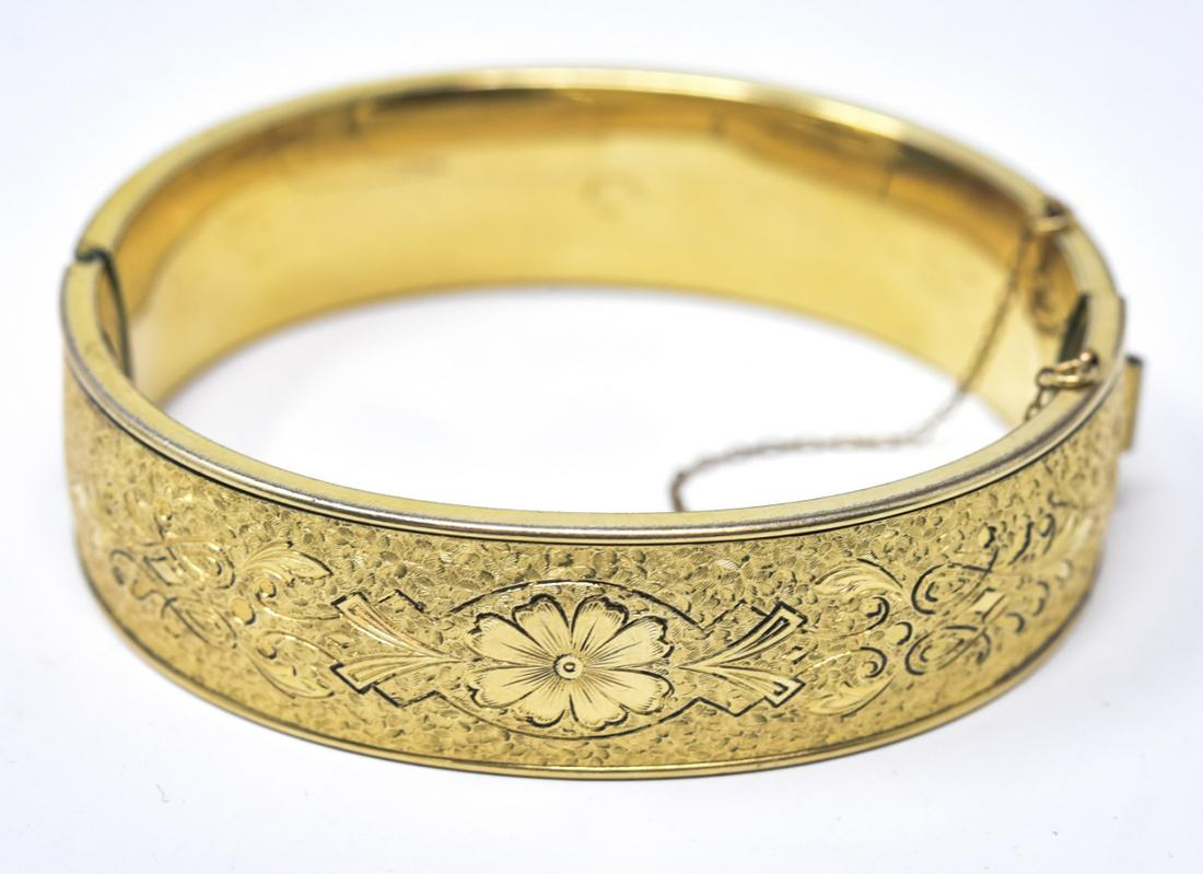 Vintage Gold Filled Floral Motif Bangle Bracelet: Vintage Gold Filled Floral Motif Bangle Bracelet w Safety Chain. Hinged bangle bracelet. Weighs approximately 24.7 grams total. Measures 2.25 inches across the interior opening. Made by Binder Bros.