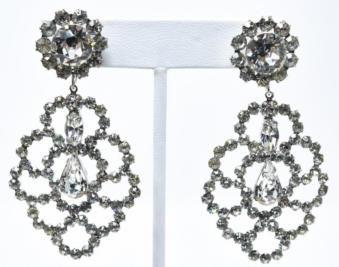 Vintage Les Bernard Rhinestone Clip on Earrings: Vintage Les Bernard Rhinestone Clip on Earrings. Having rhodium plating, clear rhinestones / faux diamonds, openwork pendant suspended from clip on. Each measures 2.75 inches in length.