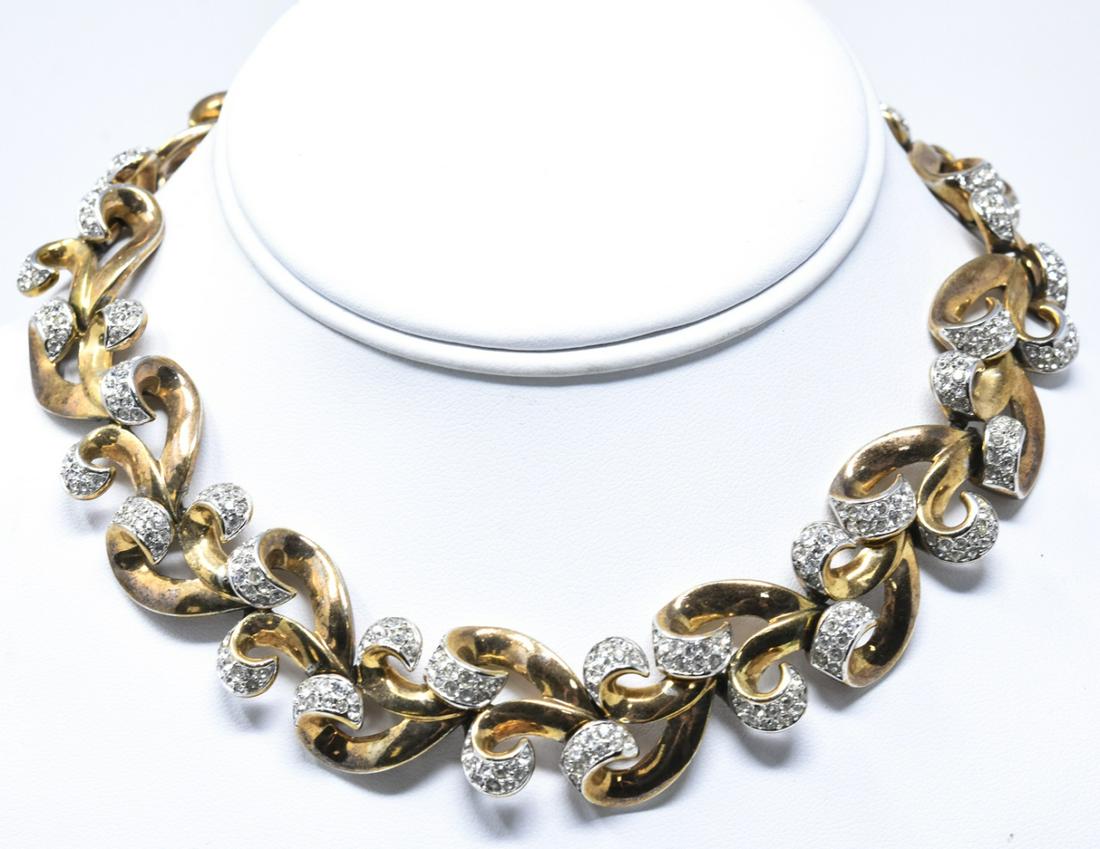 Vintage C 1960 Crown Trifari Gilt & Paste Necklace: Vintage C 1960s Crown Trifari Gilt & Paste Necklace. Signed. Articulated panel necklace, open scrollwork motif panels set with clear paste in gilt metal. Measures 14.25 inches in length.