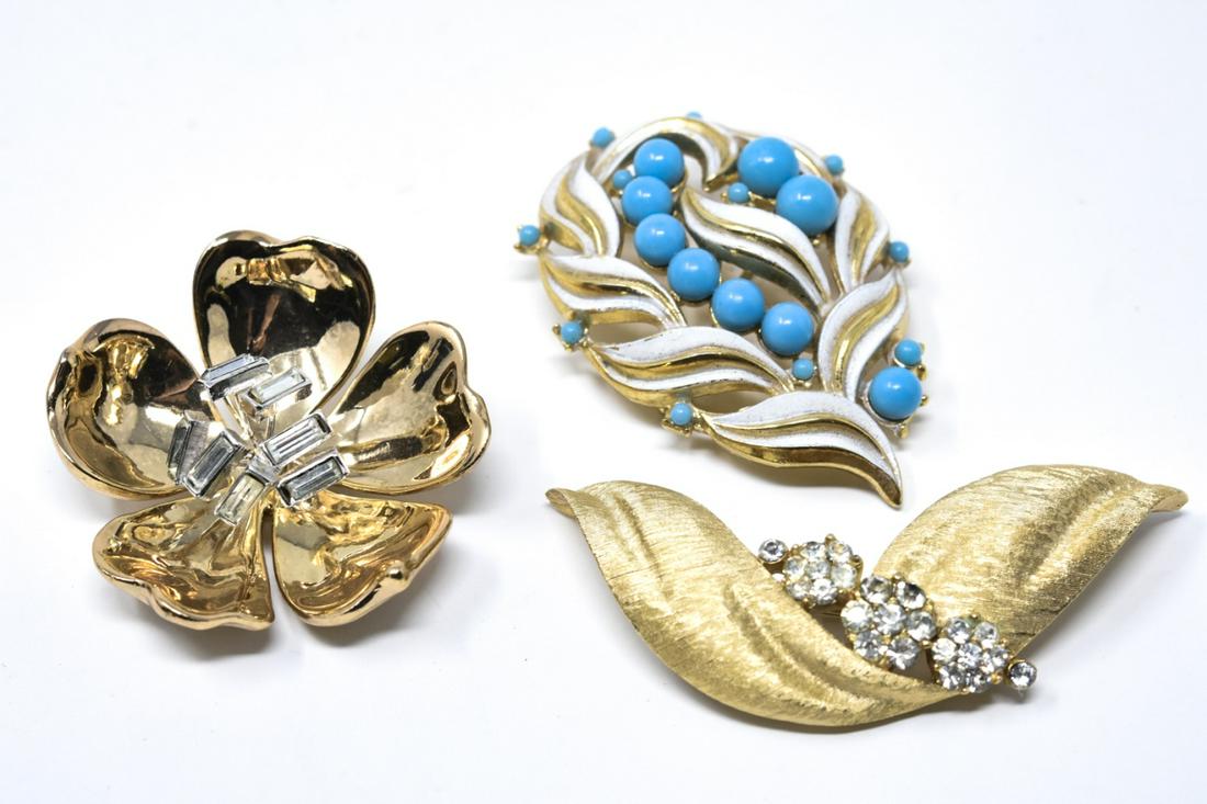 Three Vintage Gilt Metal Brooches by Trifari: Group of Three Vintage Gilt Metal Brooches by Trifari. All are signed either Tirfari or crown Trifari. Includes faux turquoise, enamel and rhinestones. Longest measures just over 2.25 inches in length