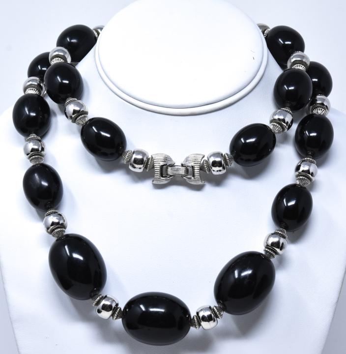 Vintage 1970s Crown Trifari Black Acrylic Necklace: Vintage C 1970s Crown Trifari Black Acrylic Necklace. Signed. Habing graduated size beads and silver tone beads. Measures 35 inches in length.