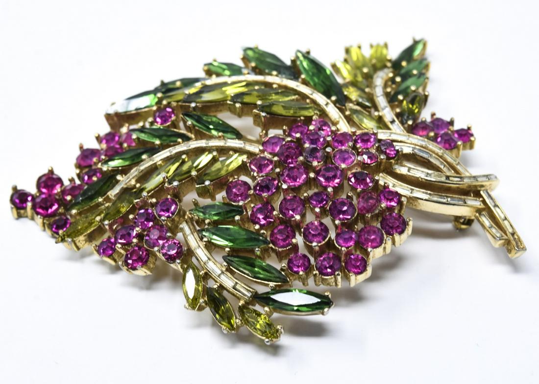 Vintage C 1970s Crown Trifari Floral Spray Brooch: Vintage C 1970s Crown Trifari Floral Spray Brooch. Signed. Gilt metal, fuchsia, green and clear color rhinestones. Measures 3.25 inches in length.