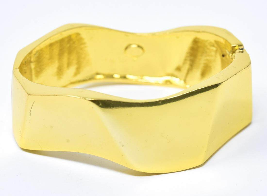 Circa 1990s Gilt Metal Kenneth Lane Bracelet: Circa 1990s Gilt Metal Kenneth Lane Bracelet. Faceted zig zag design. Signed. Clamper / hinged bangle bracelet. Measures just over 2.25 inches across interior opening