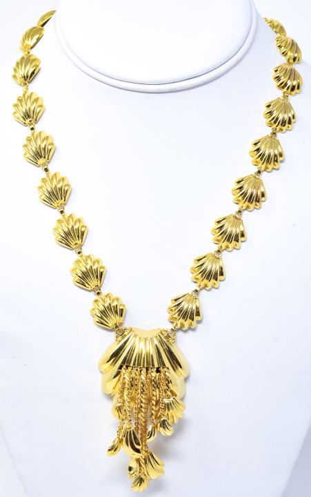 Vintage Gilt Metal Repousse Shell Necklace: Vintage Gilt Metal Repousse Shell Necklace. Unsigned. Circa 1950s. Larger shell pendant with tassel trim. Measures 18 inches in length.